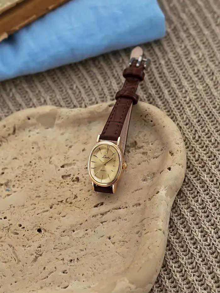 1 nouvelle montre à quartz dorée pour femme, style rétro luxueux, boîtier ovale et bracelet en cuir,