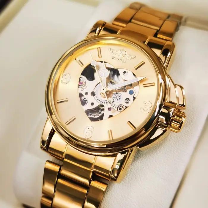Montre T-Winner automatique pour femmes élégante squelette doré bracelet acier inoxydable pour événements sportifs et occasions spéciales