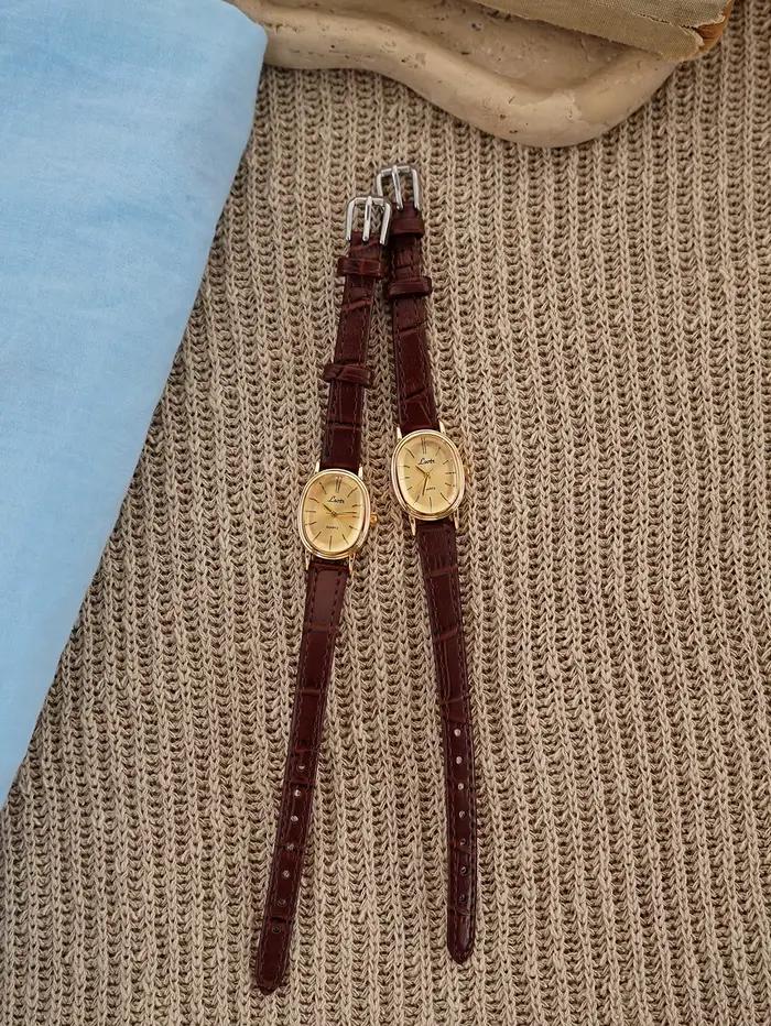 1 nouvelle montre à quartz dorée pour femme, style rétro luxueux, boîtier ovale et bracelet en cuir, montre élégante et polyvalente pour femme.