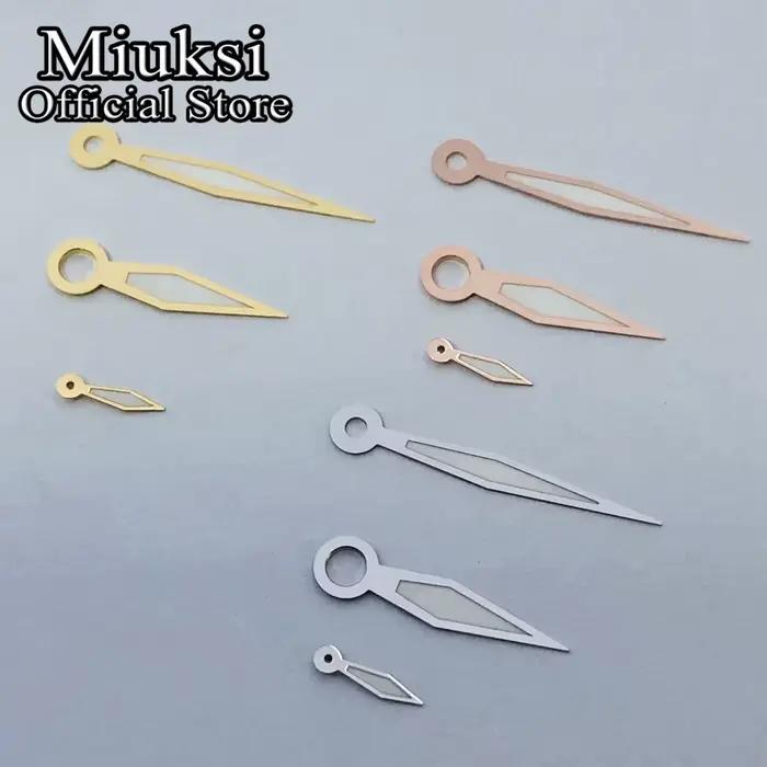 Miuksi – aiguilles de montre argent or noir blanc